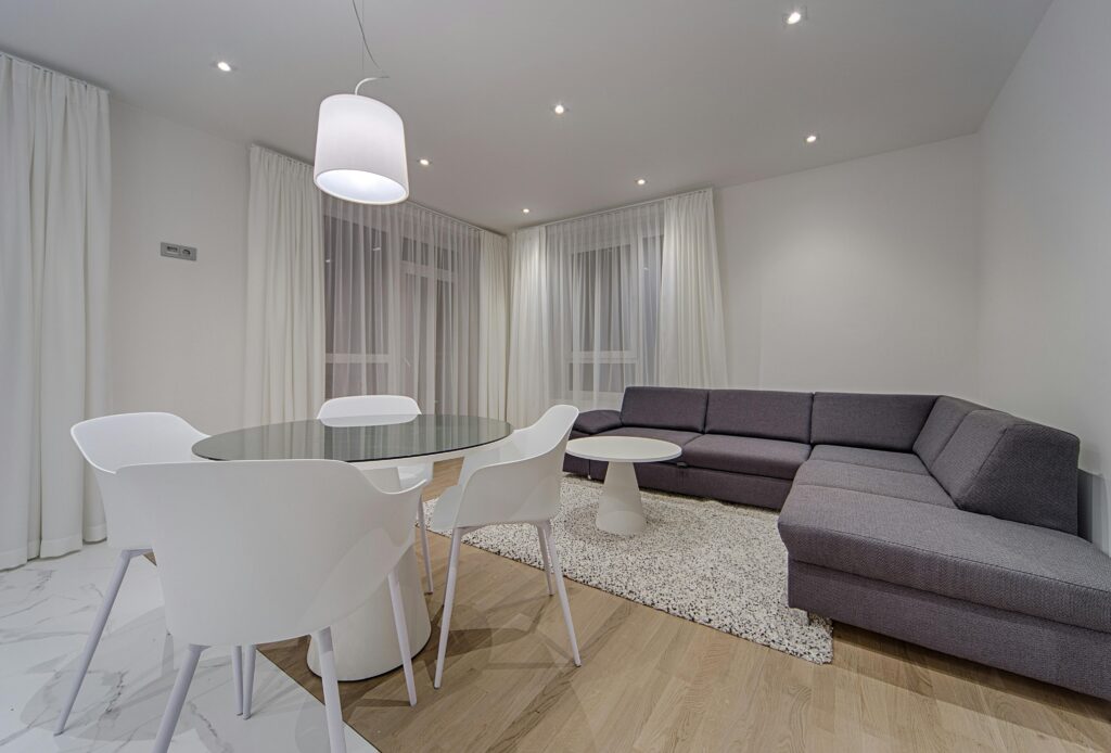 Stylish minimalist living room with round table and cozy sofa, perfect for a contemporary home.